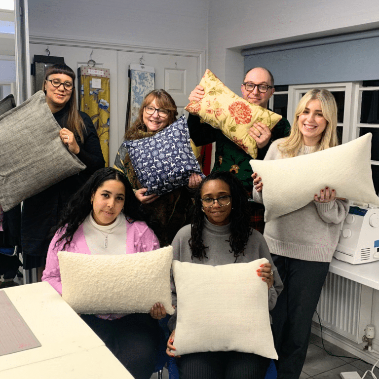 Tutors posing with cushions
