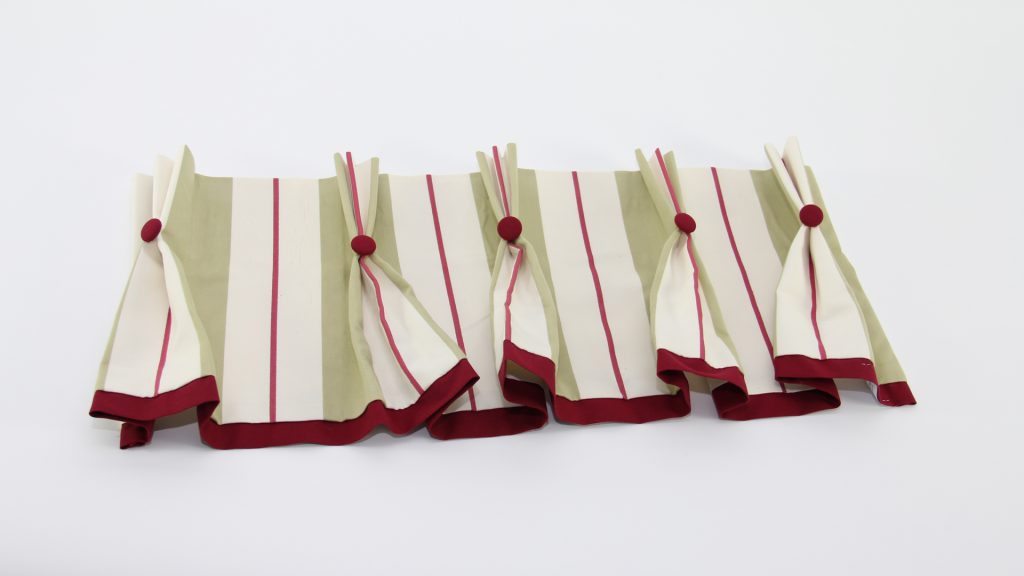 Nicoletta Perris Magnetto's striped, pleated box pelmet with button detail. The sample is by this month's Student of the Month for her Diploma in Curtain Making & Soft Furnishings. submissions Nicoletta Perris Magnetto's striped, pleated box pelmet with button detail. The sample is by this month's Student of the Month for her Diploma in Curtain Making & Soft Furnishings submissions.