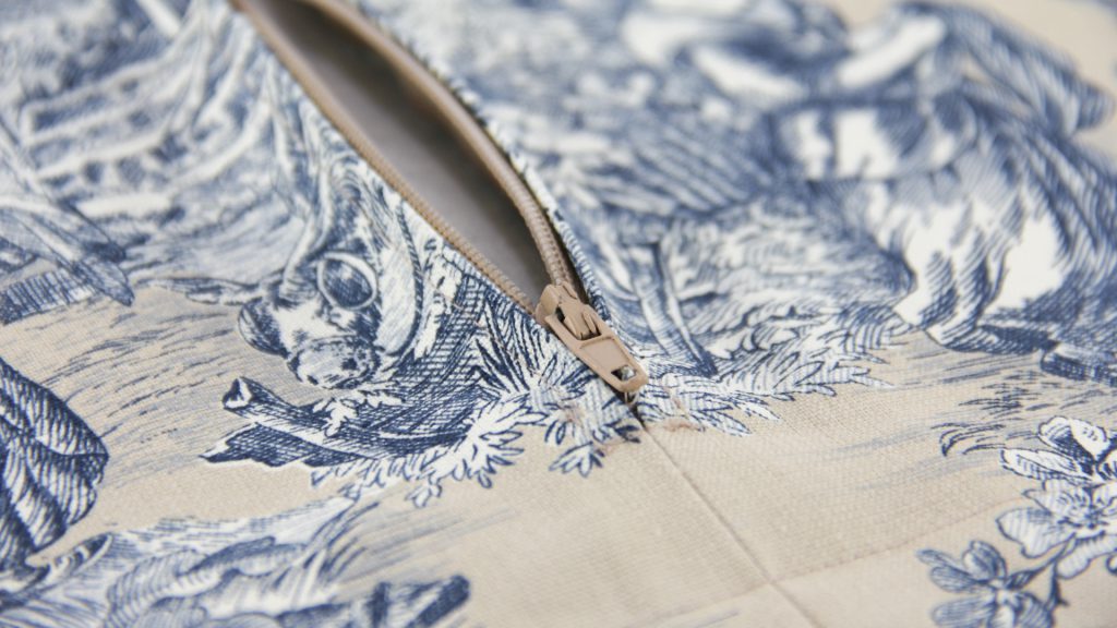 Close up detail of Nicoletta Perris Magnetto's soft furnishings cushion cover sample submission in a natural, Toile print with zip fastening by our Student of the Month, submitted as part of her Diploma in Curtain Making & Soft Furnishings work. Close up detail of Nicoletta Perris Magnetto's soft furnishings cushion cover sample submission in a natural, Toile print with zip fastening by our Student of the Month, submitted as part of her Diploma in Curtain Making & Soft Furnishings work.